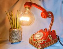 Red 1970s telephone upcycled into a lamp