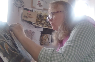 Picture of Jane Murdock working on a pastel drawing of mushrooms
