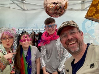 A picture of Val & Trev (Beth and Ian) during their community event with an array of props and costumes