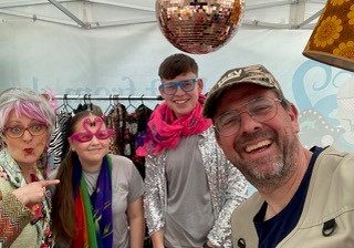 A picture of Val & Trev (Beth and Ian) during their community event with an array of props and costumes
