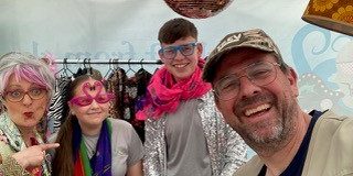 A picture of Val & Trev (Beth and Ian) during their community event with an array of props and costumes