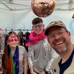 A picture of Val & Trev (Beth and Ian) during their community event with an array of props and costumes