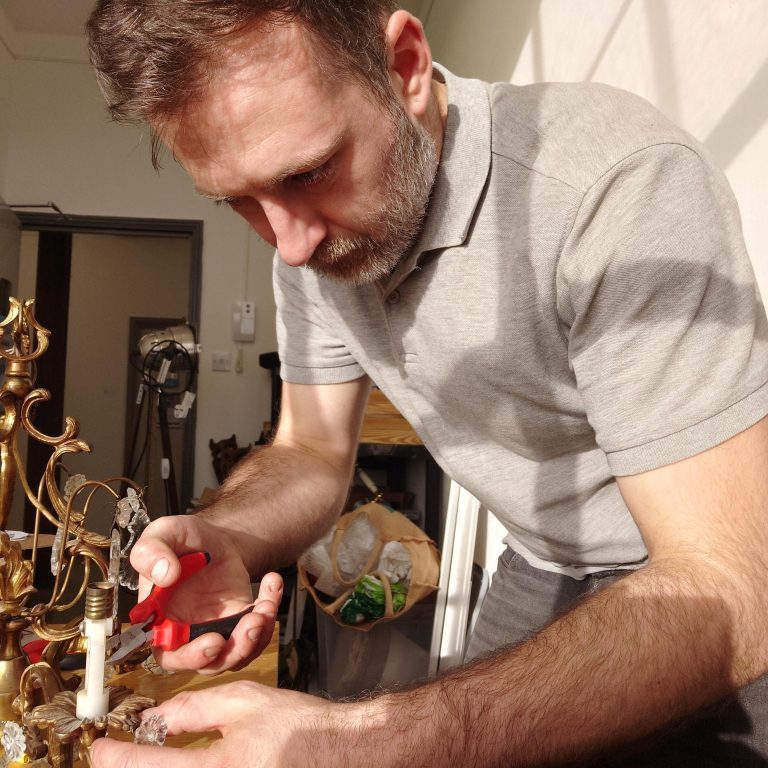 Picture of Scott in his studio repairing and upcycling a lamp